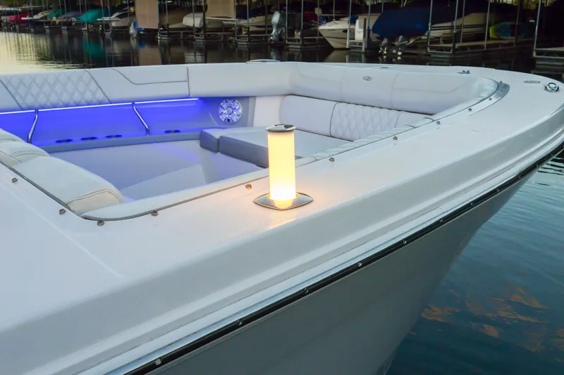 Only Fins Yacht Photos Pics 2021 Regal 38 SAV boat with illuminated seating area and ambient lighting at a marina.