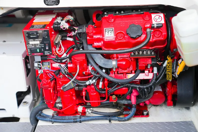 Only Fins Yacht Photos Pics Engine compartment of a 2021 Regal 38 SAV boat, featuring a red multiport EFI system.
