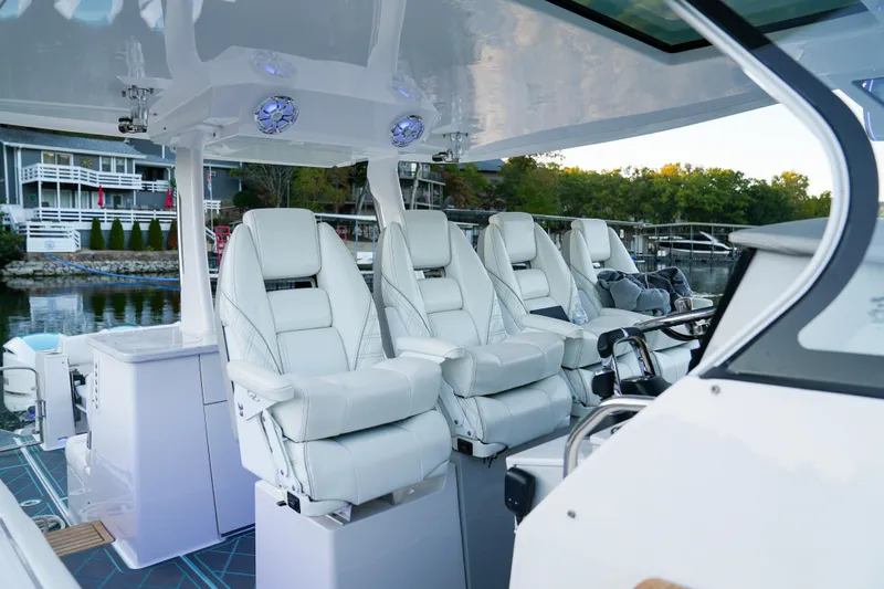 Only Fins Yacht Photos Pics 2021 Regal 38 SAV boat interior with luxurious white seating and modern design.