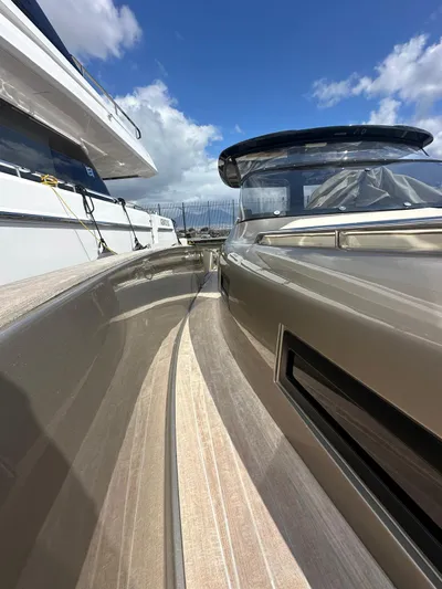  Yacht Photos Pics 2024 Solaris Power 44 Open yacht, sleek design, docked under a blue sky.