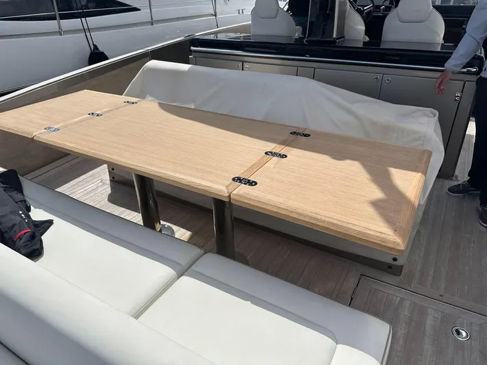  Yacht Photos Pics 2024 Solaris Power 44 Open yacht with elegant wooden table and white seating.