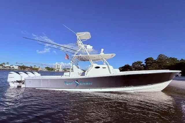  Yacht Photos Pics 2017 Regulator 41 boat with triple engines on calm water under clear blue sky.