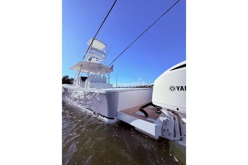  Yacht Photos Pics 2017 Regulator 41 boat with Yamaha engine cruising on water under clear blue sky.