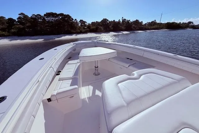  Yacht Photos Pics 2017 Regulator 41 boat with spacious seating, docked by a serene shoreline.