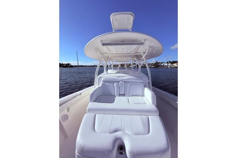  Yacht Photos Pics 2017 Regulator 41 boat with white seating, on calm water under clear blue sky.