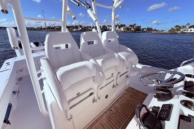  Yacht Photos Pics 2017 Regulator 41 boat interior with white seating and steering wheel on a sunny day.