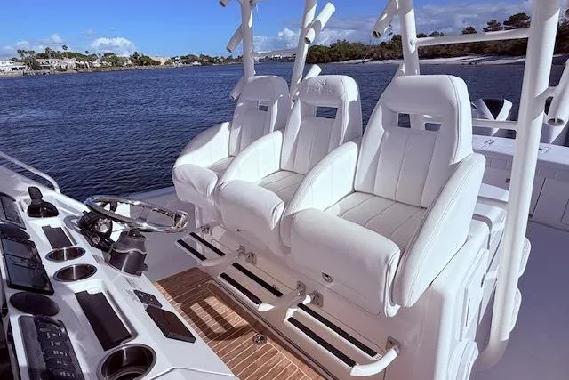  Yacht Photos Pics 2017 Regulator 41 boat interior with white seating and control panel, on a scenic waterway.