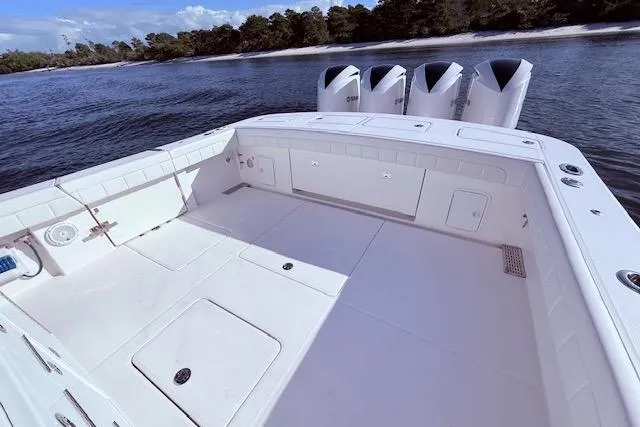  Yacht Photos Pics 2017 Regulator 41 boat deck with quad engines, near shoreline.