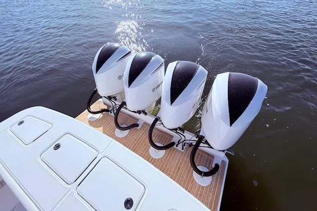  Yacht Photos Pics Four powerful outboard engines on a 2017 Regulator 41 boat, glistening on the water.