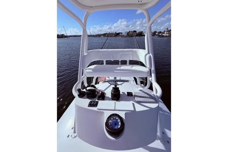  Yacht Photos Pics 2017 Regulator 41 boat helm with steering wheel and controls, overlooking calm waters.