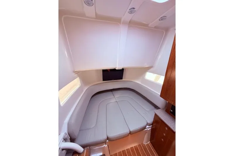  Yacht Photos Pics 2017 Regulator 41 boat interior with cushioned seating and wood accents.