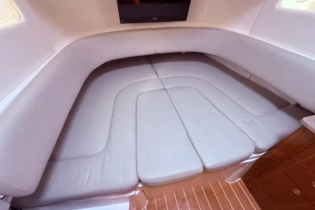  Yacht Photos Pics 2017 Regulator 41 boat interior with cushioned seating and wooden flooring.