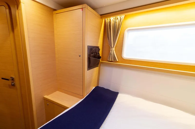 Why Not Yacht Photos Pics Interior cabin of 2019 Lagoon 450F yacht with wooden finish and window.