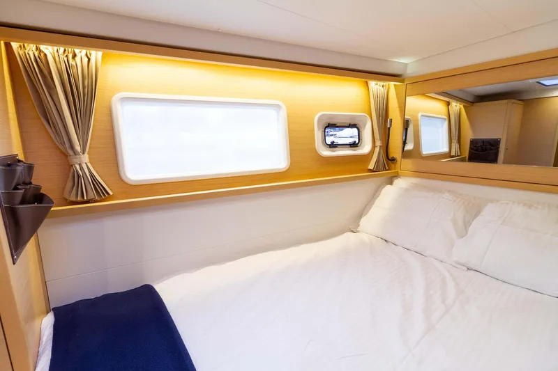 Why Not Yacht Photos Pics Luxurious cabin interior of 2019 Lagoon 450F yacht with cozy bed and elegant decor.