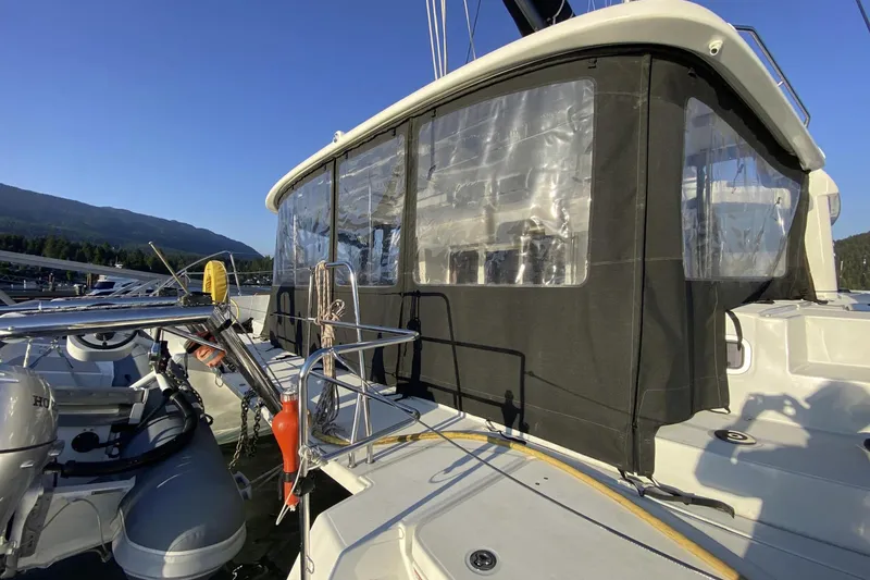 Why Not Yacht Photos Pics 2019 Lagoon 450F yacht with enclosed cockpit, docked in a marina under clear blue skies.
