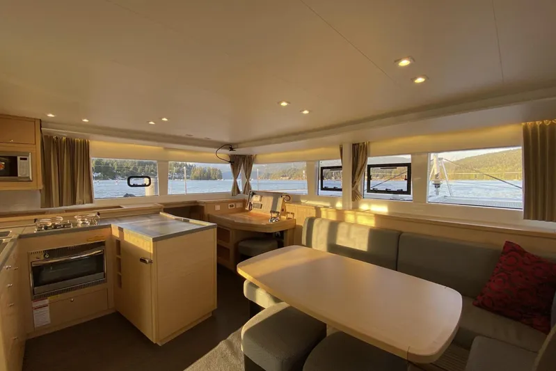 Why Not Yacht Photos Pics Interior of 2019 Lagoon 450F catamaran with modern kitchen and dining area, scenic window views.