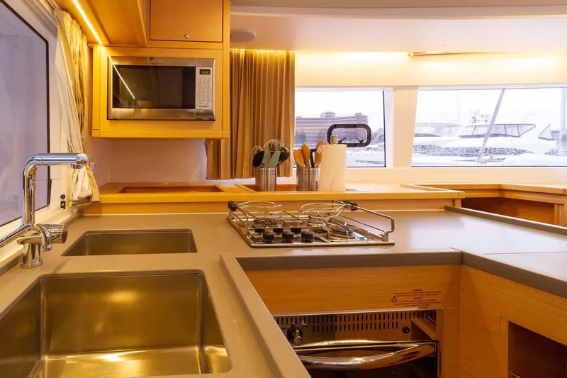 Why Not Yacht Photos Pics Modern kitchen interior of 2019 Lagoon 450F yacht with stainless steel sink and appliances.