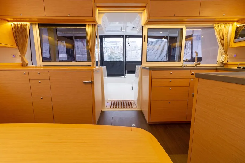 Why Not Yacht Photos Pics Interior of 2019 Lagoon 450F yacht, featuring modern wood cabinetry and spacious layout.