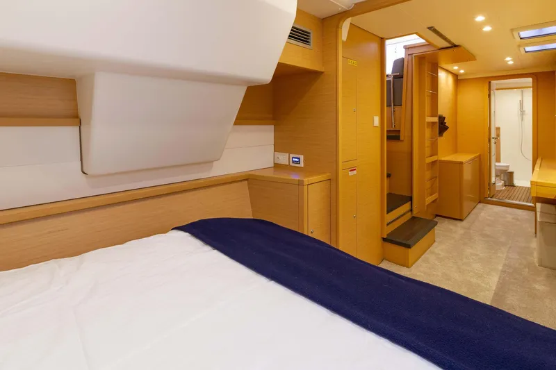 Why Not Yacht Photos Pics Interior of 2019 Lagoon 450F yacht cabin with modern wood finish and cozy bedding.