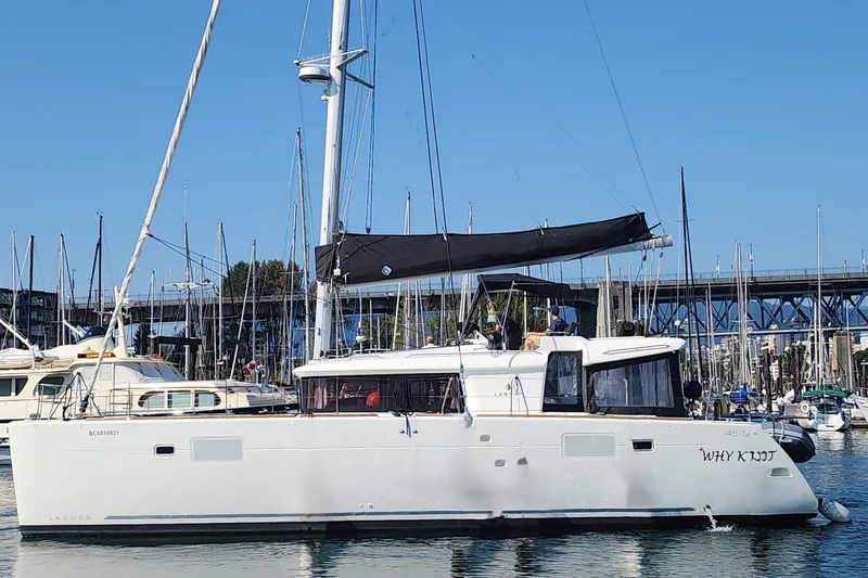 Why Not Yacht Photos Pics 2019 Lagoon 450F catamaran docked in a marina under clear blue skies.