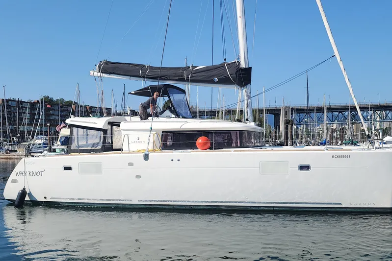 Why Not Yacht Photos Pics 2019 Lagoon 450F catamaran docked in marina, clear sky, person on deck.