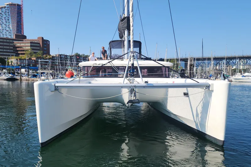 Why Not Yacht Photos Pics 2019 Lagoon 450F catamaran docked in marina, cityscape in background.