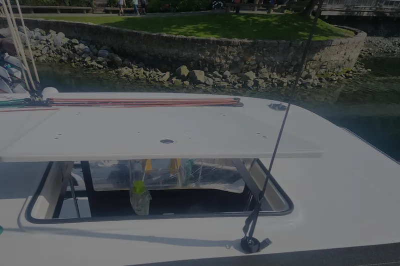 Why Not Yacht Photos Pics Lagoon 450F 2019 yacht deck with open hatch near rocky shoreline.