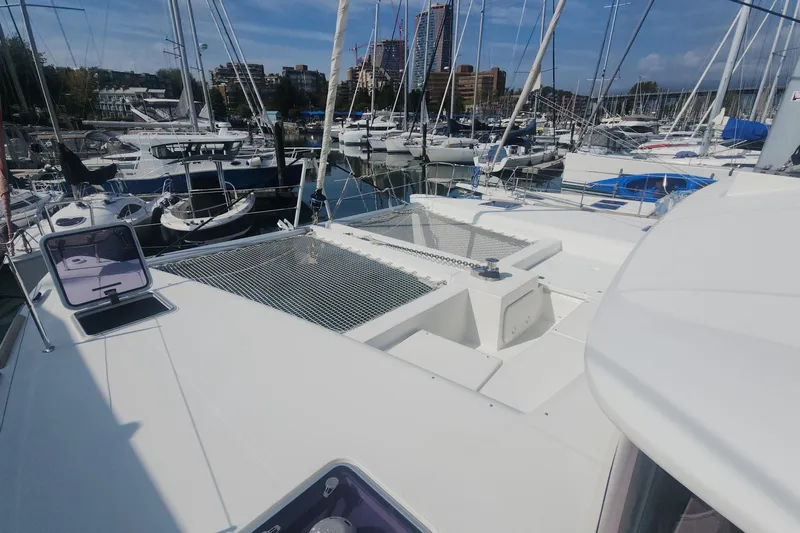 Why Not Yacht Photos Pics 2019 Lagoon 450F catamaran docked in a marina, surrounded by other boats.