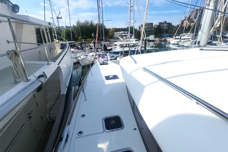 Why Not Yacht Photos Pics 2019 Lagoon 450F catamaran docked in a marina, surrounded by other boats.