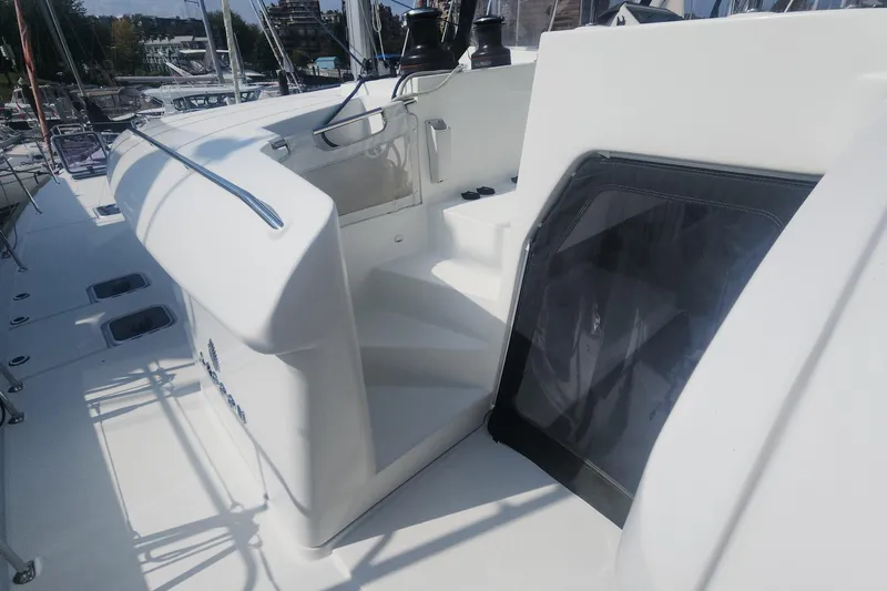 Why Not Yacht Photos Pics 2019 Lagoon 450F yacht deck with stairs and railing in marina setting.