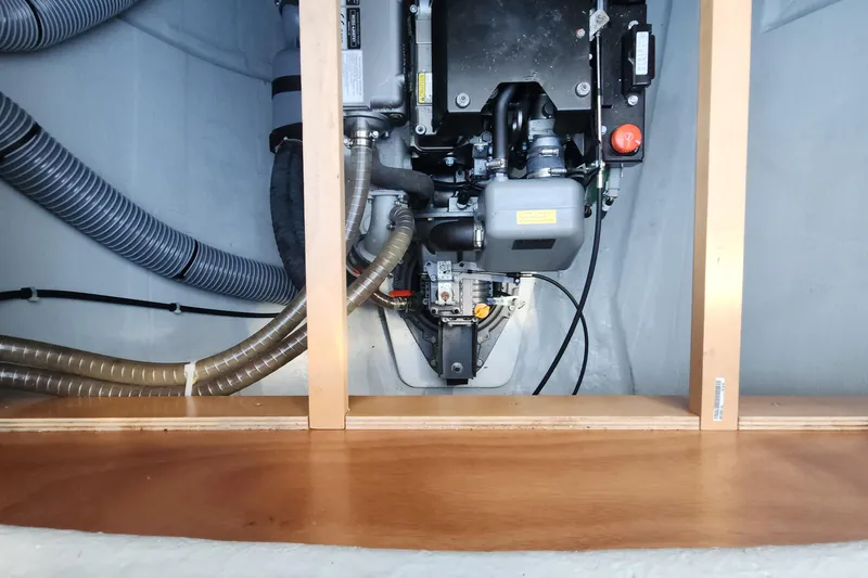 Why Not Yacht Photos Pics Engine compartment of a 2019 Lagoon 450F catamaran, showcasing mechanical components and hoses.