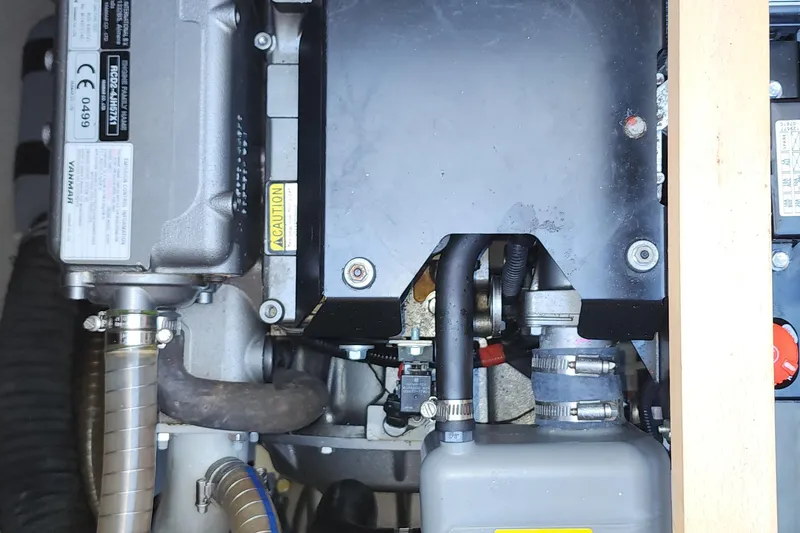 Why Not Yacht Photos Pics Engine compartment of a 2019 Lagoon 450F catamaran, showcasing mechanical components and hoses.