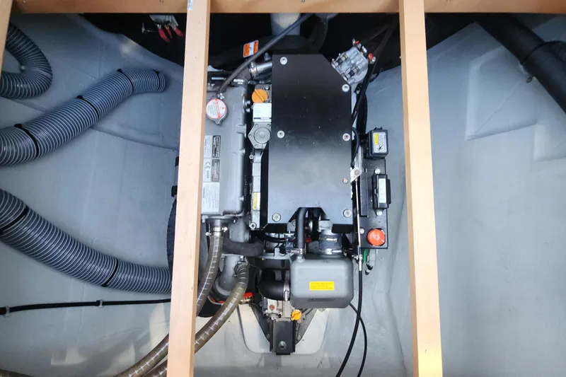 Why Not Yacht Photos Pics Engine compartment of a 2019 Lagoon 450F catamaran, showcasing mechanical components and hoses.