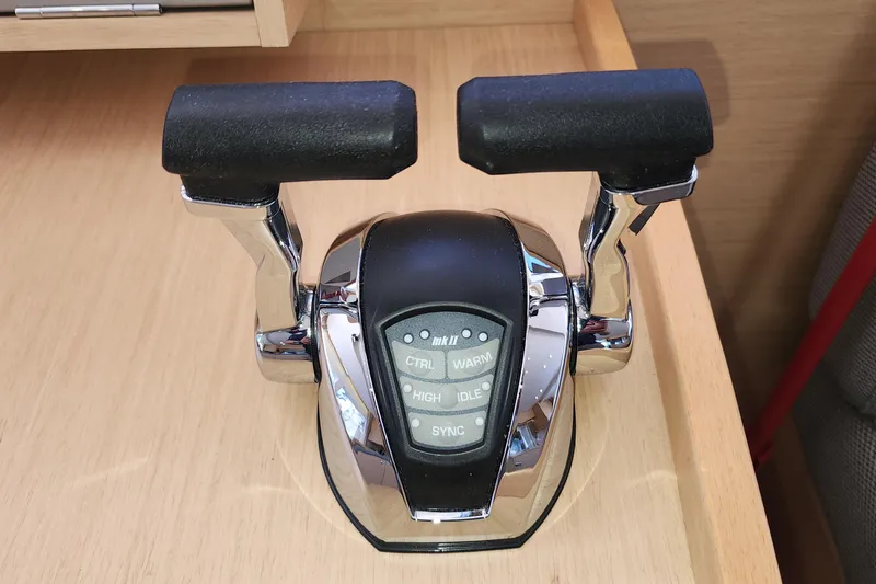Why Not Yacht Photos Pics Throttle control lever on a 2019 Lagoon 450F yacht, featuring dual handles and control buttons.