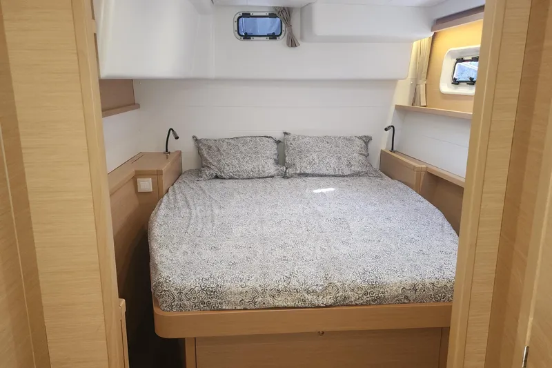 Why Not Yacht Photos Pics 2019 Lagoon 450F cabin interior with cozy bed and wooden accents.