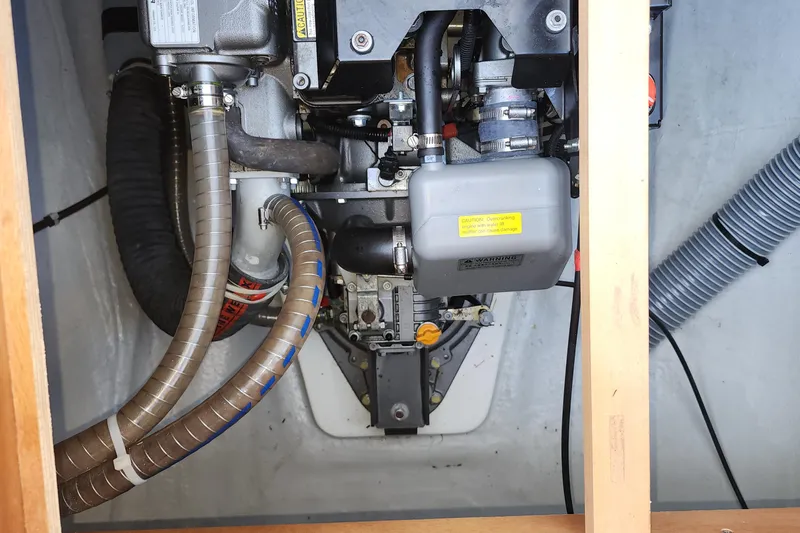 Why Not Yacht Photos Pics Engine compartment of a 2019 Lagoon 450F catamaran, showcasing mechanical components and hoses.