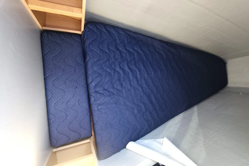 Why Not Yacht Photos Pics Interior cabin of 2019 Lagoon 450F with blue mattress and wooden shelves.