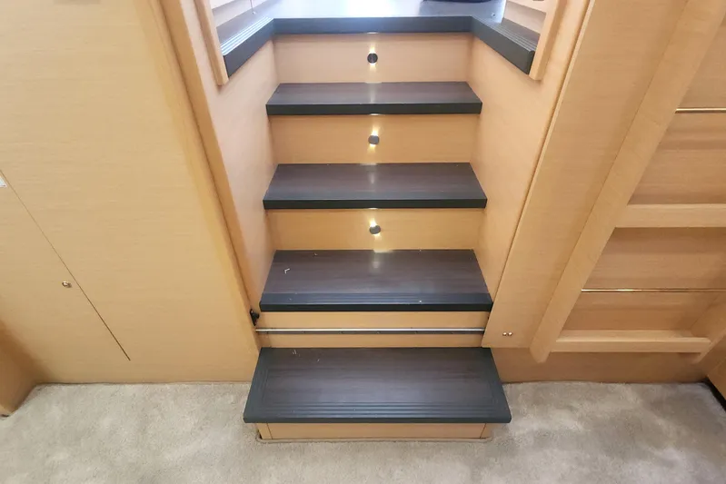 Why Not Yacht Photos Pics Interior stairs of a 2019 Lagoon 450F yacht with wooden steps and LED lighting.