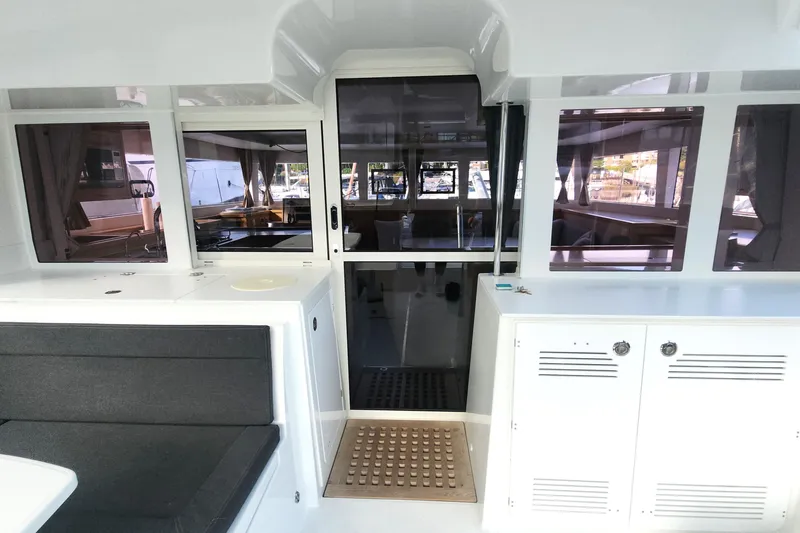 Why Not Yacht Photos Pics Interior view of 2019 Lagoon 450F catamaran, featuring seating and cabinetry.