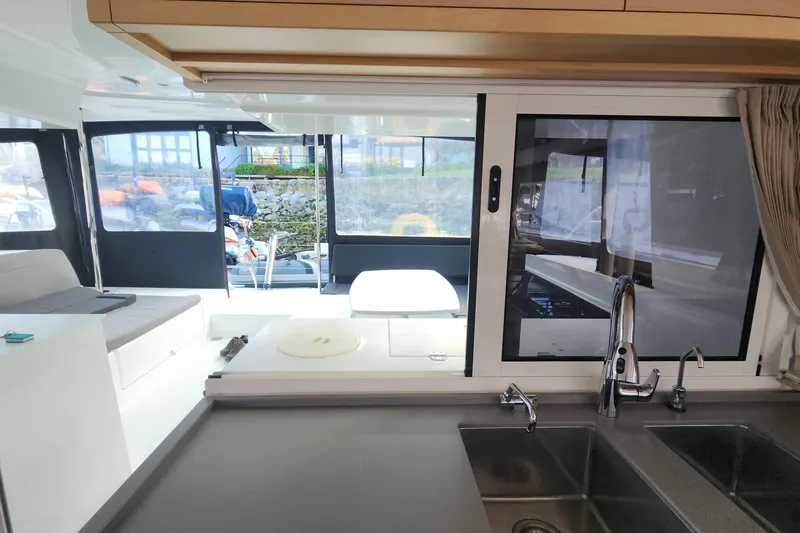 Why Not Yacht Photos Pics Interior of 2019 Lagoon 450F catamaran, featuring modern kitchen and spacious seating area.