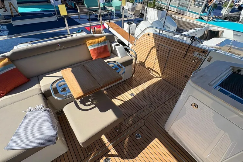  Yacht Photos Pics Luxurious deck of 2026 Wellcraft 44 Explorer yacht with seating and wooden table.