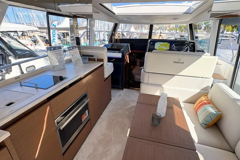  Yacht Photos Pics Luxurious interior of 2026 Wellcraft 44 Explorer yacht with modern kitchen and seating area.