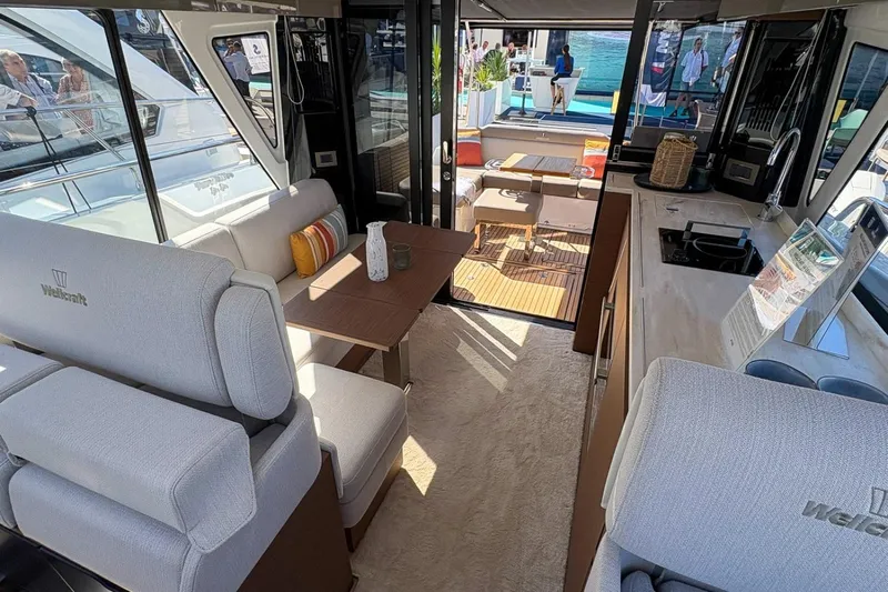  Yacht Photos Pics Interior of 2026 Wellcraft 44 Explorer yacht, featuring modern seating and kitchen area.