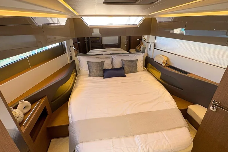  Yacht Photos Pics Luxurious bedroom interior of 2026 Wellcraft 44 Explorer yacht, featuring modern design and cozy bedding.