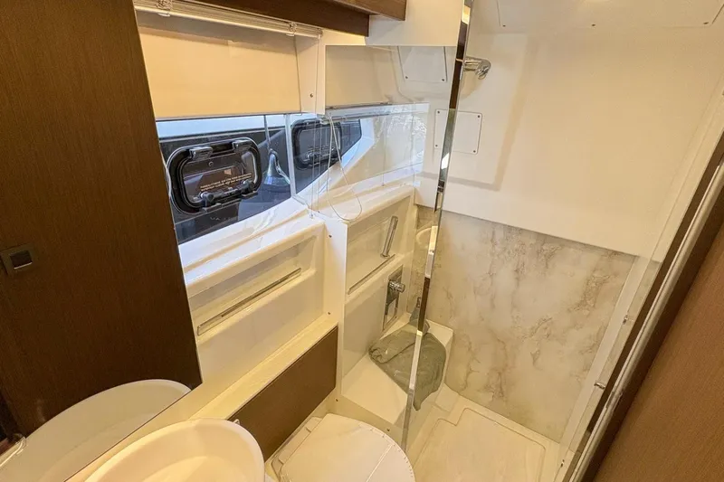  Yacht Photos Pics Luxurious bathroom interior of 2026 Wellcraft 44 Explorer yacht, featuring modern fixtures and elegant design.