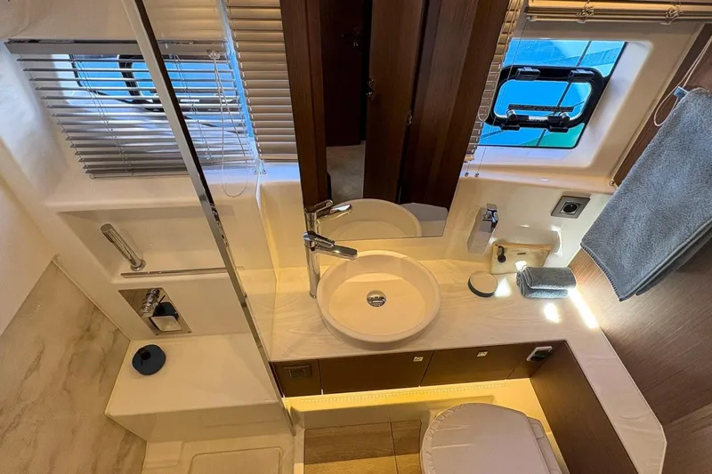  Yacht Photos Pics Luxurious bathroom interior of 2026 Wellcraft 44 Explorer yacht, featuring modern fixtures and elegant design.