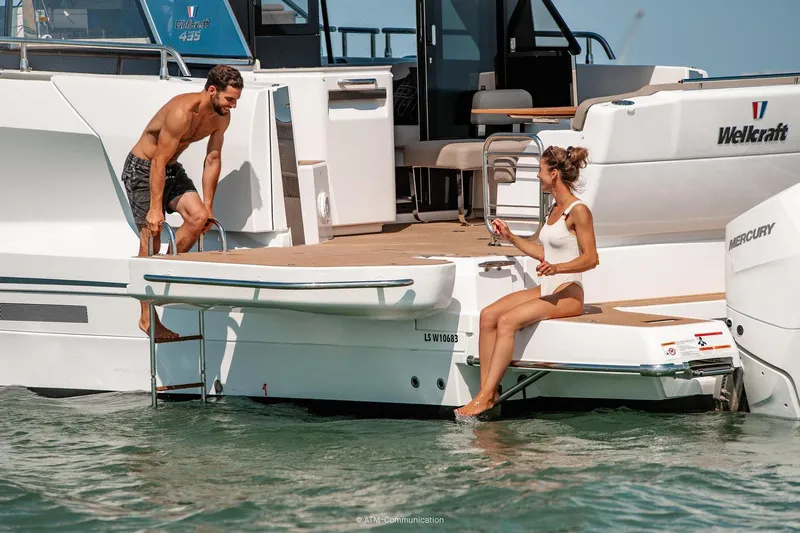  Yacht Photos Pics Couple enjoying leisure time on 2026 Wellcraft 44 Explorer yacht deck.
