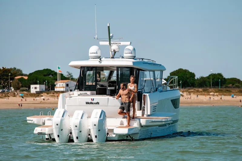  Yacht Photos Pics 2026 Wellcraft 44 Explorer yacht on water with people enjoying the view.