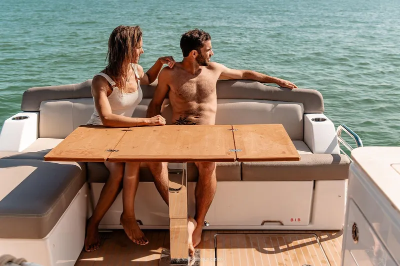  Yacht Photos Pics Couple relaxing on Wellcraft 44 Explorer yacht, 2026, enjoying a sunny day at sea.