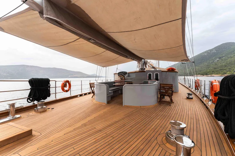 Le Pietre Yacht Photos Pics Luxurious 2009 custom sailing yacht with spacious wooden deck and scenic coastal backdrop.